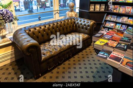 A worn out leather couch for customers, inside Hatchard bookshop, Piccadilly, London, England, UK. Stock Photo