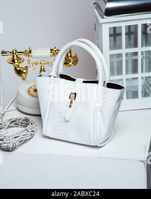 white snake-print bag with golden detail Stock Photo