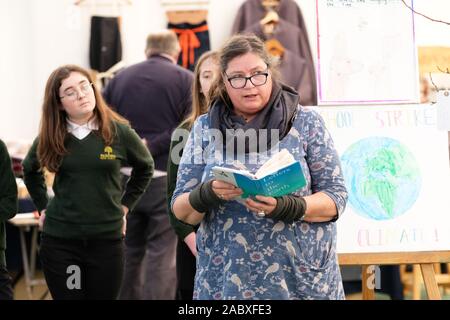 Hay Festival Winter Weekend, Hay on Wye, Powys, Wales, UK - Friday 29th November 2019 - Poet and illustrator Jackie Morris reads beside a Wishing Tree with local school students as part of the local Youth Climate Strike - Credit: Steven May/Alamy Live News Stock Photo
