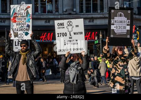 Oxford Circus, London, UK. 29th Nov 2019. Extinction Rebellion UK protest the excesses of consumptionon on Black Friday, particularly in the fashion industry, with a silent protest at Oxford Circus. Credit: Guy Bell/Alamy Live News Stock Photo