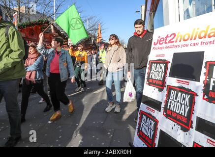 Southampton, UK. 29th November 2019. Extinction Rebellion campaigners march through Southampton's shopping precinct on Black Friday as part of the Global Climate Change Strike. Credit Stuart Martin/Alamy Live News Stock Photo