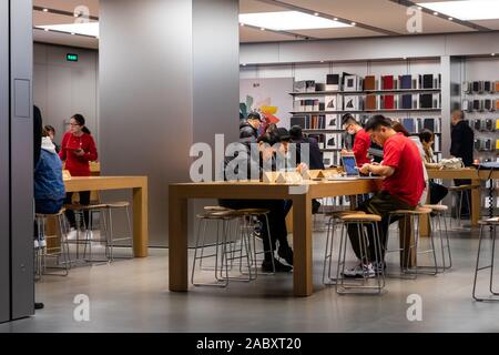 The logo of Apple is lit up in red to mark the upcoming World AIDS Day at the Apple Store on the East Nanjing Road pedestrian street in Shanghai, Chin Stock Photo