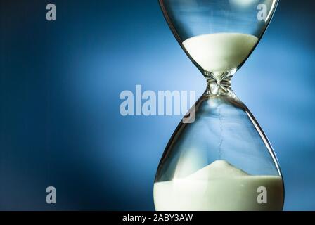 Sand running through an hourglass or egg timer Stock Photo