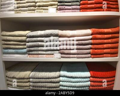 A pile of multi-colored terry towels on a shelf. Stock Photo