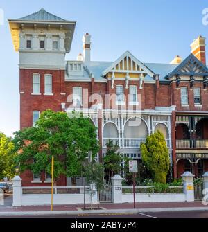 Row of 4 terrace houses red brick buildings in Federation architecture style on Beaufort St Northbridge Perth Western Australia. Stock Photo