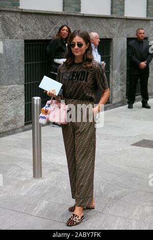 MILAN ITALY SEPTEMBER 19 2019 Woman with brown Fendi dress and pink leather bag before Emporio Armani fashion show Milan Fashion Week street sty Stock Photo Alamy