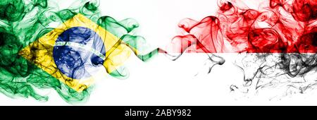 Brazil, Brazilian vs Indonesia, Indonesian smoky mystic flags placed side by side. Thick colored silky abstract smoke flags combination Stock Photo