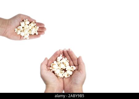 Hand holding popcorn isolated on the white background, space for text Stock Photo
