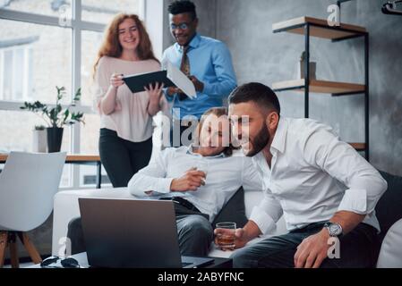 Great expectations. Group of multiracial office workers in formal clothes talking about tasks and plans Stock Photo