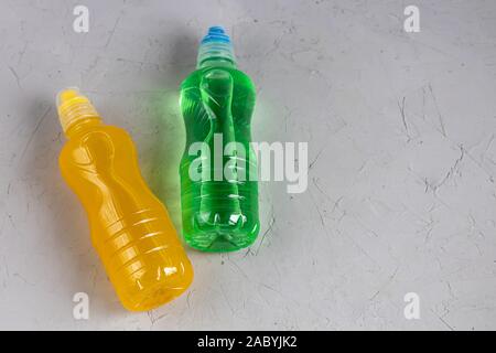 Fresh, fruit fluid for a healthy diet. Isotonic, energy drink. Two bottles with colorful water, a sports drink. Stock Photo