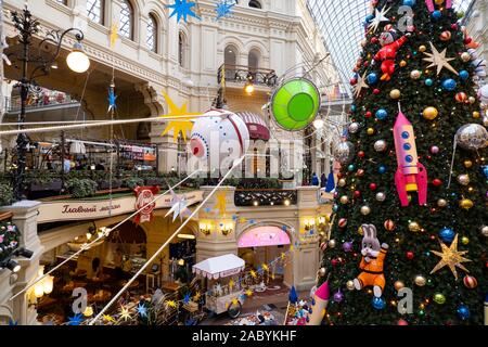 Moscow, Russia - November 25, 2019: New Year tree with cartoon toys in the State Department Store on Red Square. Christmas in the center of Moscow. Design on a space theme Stock Photo