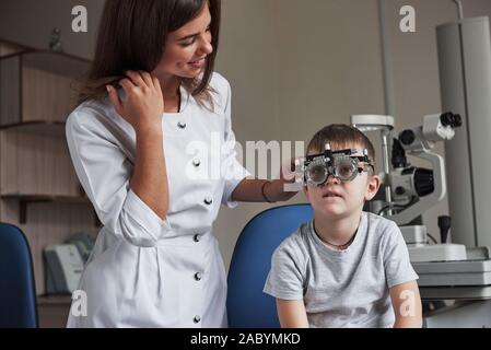 Reading the letters. Child sitting in the doctor's cabinet and have tested his visual acuity Stock Photo