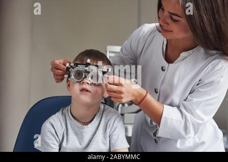 Working in process. Child sitting in the doctor's cabinet and have tested his visual acuity Stock Photo