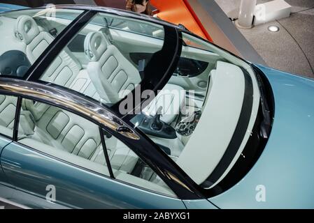 View from the top on panoramic roof and hood of stylish, modern and expensive blue car with white interior Stock Photo