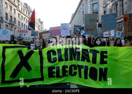 Environmental protesters holding a large banner and placards while shouting slogans during the strike.Children, young people, and adults join together in a strike to highlight the climate and ecological crisis caused by fossil fuels, plastic pollution, deforestation among others. They demand for a strong environmental bill to restore nature and direct climate actions to tackle the crisis. Stock Photo