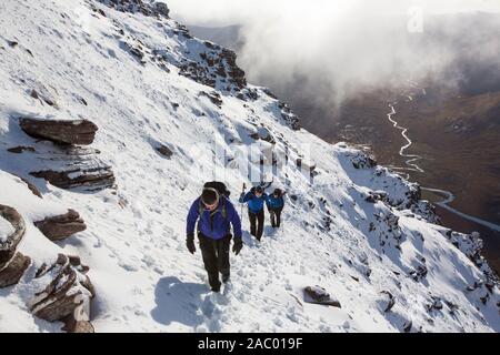 Mountaineers on the Munro An Teallach, one of Scotlands finest mountain traverses, above Dundonell, Scotland, UK looking down into the Strath na Sealg Stock Photo