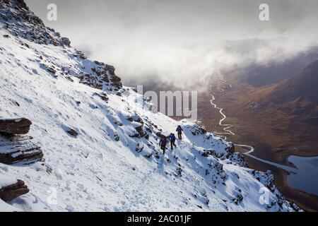 Mountaineers on the Munro An Teallach, one of Scotlands finest mountain traverses, above Dundonell, Scotland, UK looking down into the Strath na Sealg Stock Photo