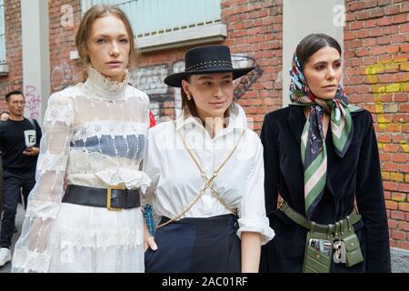 MILAN, ITALY - SEPTEMBER 19, 2019: Women before Fendi fashion show, Milan Fashion Week street style Stock Photo