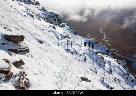 Mountaineers on the Munro An Teallach, one of Scotlands finest mountain traverses, above Dundonell, Scotland, UK looking down into the Strath na Sealg Stock Photo