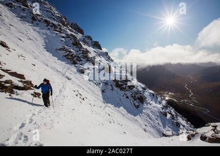 Mountaineers on the Munro An Teallach, one of Scotlands finest mountain traverses, above Dundonell, Scotland, UK looking down into the Strath na Sealg Stock Photo