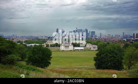 GREENWICH, LONDON, UNITED KINGDOM - JUNE 24, 2019: Panoramic view from historic Greenwich to the modern Canary Wharf business district skyline.