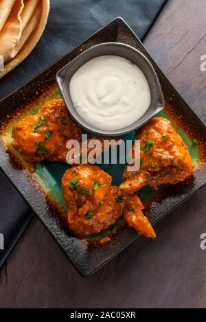 Hot and spicy buffalo wings with blue cheese dipping sauce Stock Photo