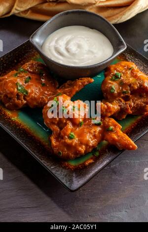 Hot and spicy buffalo wings with blue cheese dipping sauce Stock Photo