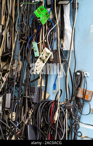 Old unused power cords for various devices in the market for sale Stock Photo