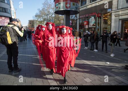 Westminster, London, UK. 29 November 2019. Environmental campaigners Red Rebellion protest peacefully along Trafalgar Square to reach Oxford Circus. Protesters demand decisive action from the UK Government on the global environmental crisis. Stock Photo