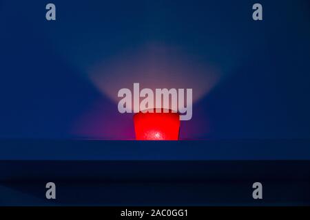 red candle on blue background inside a spa Stock Photo
