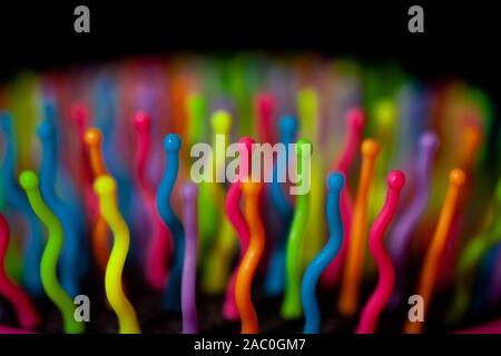 Abstract background of colorful waves in motion on black. Bokeh of defocused curves, blurred neon blue, yellow and red leds, imitation of glowing sper Stock Photo