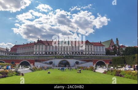 Poland, Warsaw - August 22, 2019: Resting people on the lawn in front of the royal castle in Warsaw Stock Photo