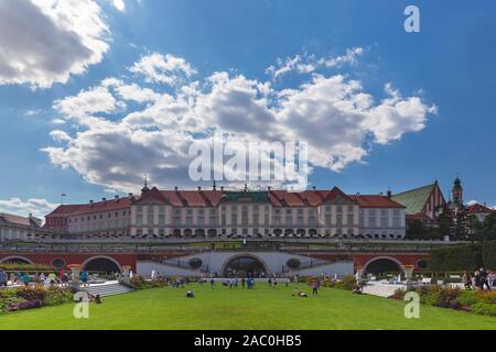 Poland, Warsaw - August 22, 2019: Resting people on the lawn in front of the royal castle in Warsaw Stock Photo