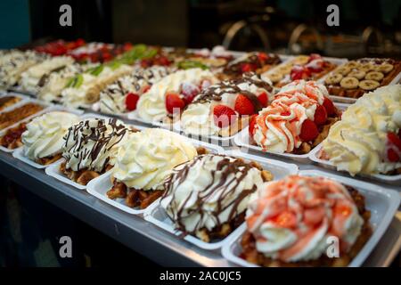 Indulgent Belgian waffles covered in creamy toppings at a stall in Brussels, Belgium. Stock Photo