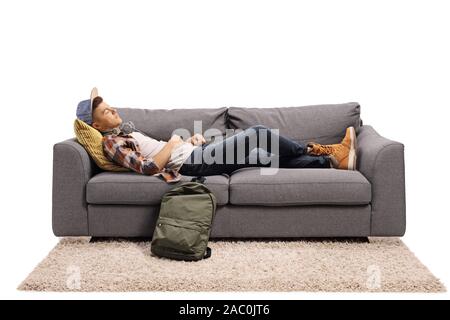 Male student sleeping on a sofa isolated on white background Stock Photo