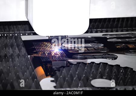 Machining CNC laser cutting metal sheet,High precision technology Stock Photo