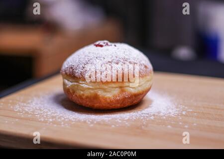 Hanukkah food doughnuts with jelly and sugar powder with bookeh background. Jewish holiday Hanukkah concept and background. Copy space for text. Shall Stock Photo