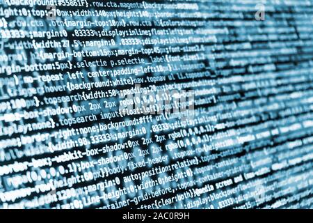 Compressed CSS programming code on screen in blue tones Stock Photo