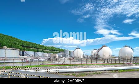 Oil and gas refinery storage tank and Detail of equipment oil pipeline steel with valve for industrail petroleum. Stock Photo