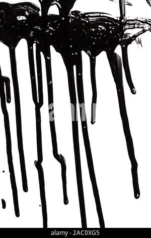 Close up of black paint leaking isolated on white background Stock Photo