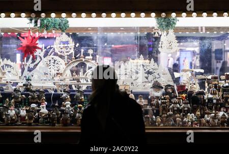 Berlin, Germany. 29th Nov, 2019. A visitor looks at merchandises displayed at a shop of the Christmas market on Alexanderplatz in Berlin, Germany, on Nov. 29, 2019. Credit: Shan Yuqi/Xinhua/Alamy Live News Stock Photo