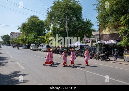 Buddhist nuns collecting alms in Yangon streets, Myanmar Stock Photo