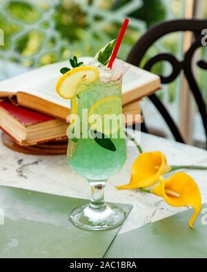 green lemon cocktail with ice and lemon slices Stock Photo