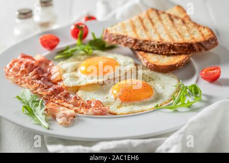Fresh breakfast with eggs, bacon and tomatoes Stock Photo
