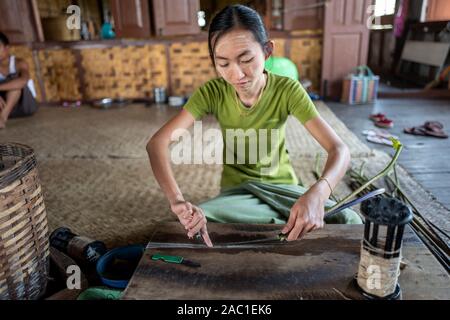 Traditional lotus plant weaving handicraft worker on Inle Lake in Myanmar, Asia Stock Photo