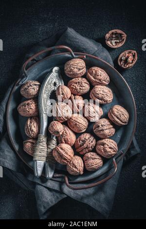 Tasty walnuts with on rustic metal plate Stock Photo