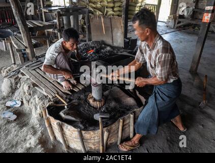 Traditional blacksmith workers on Inle Lake in Myanmar, Asia Stock Photo