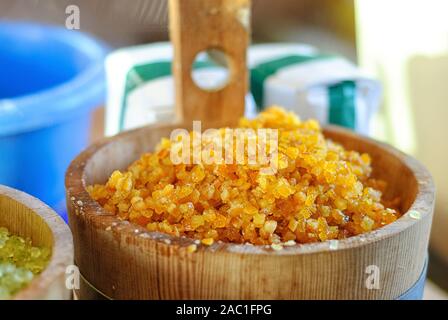 Candied orange peel in wooden bowl. Orange candy in small wood barrel. Ingredients for Traditional Christmas stollen -Christmas cake, German festive dessert. Stock Photo
