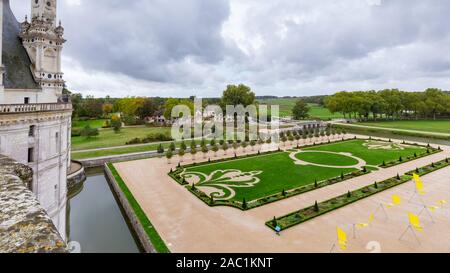 French formal garden and entrance of Chateau de Chambord, view from the roof of the castle, in Loire valley, Centre Valle de Loire in France