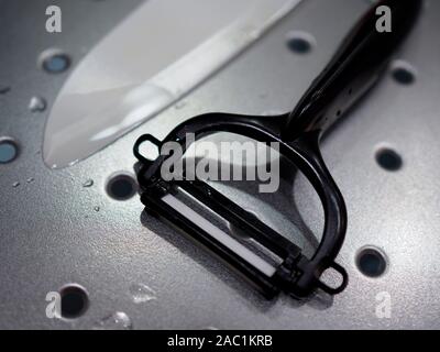 A ceramic potato peeler and knife Stock Photo